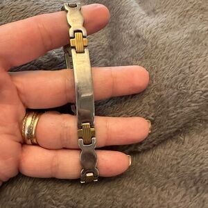 Heavy Bracelet in Stainless steel with golden accents.